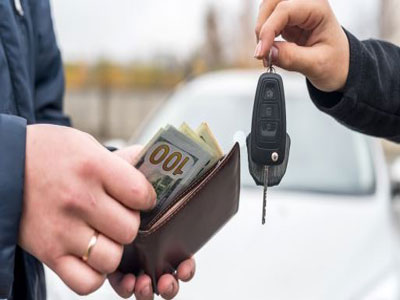 Hand handing over keys to clunker showing money